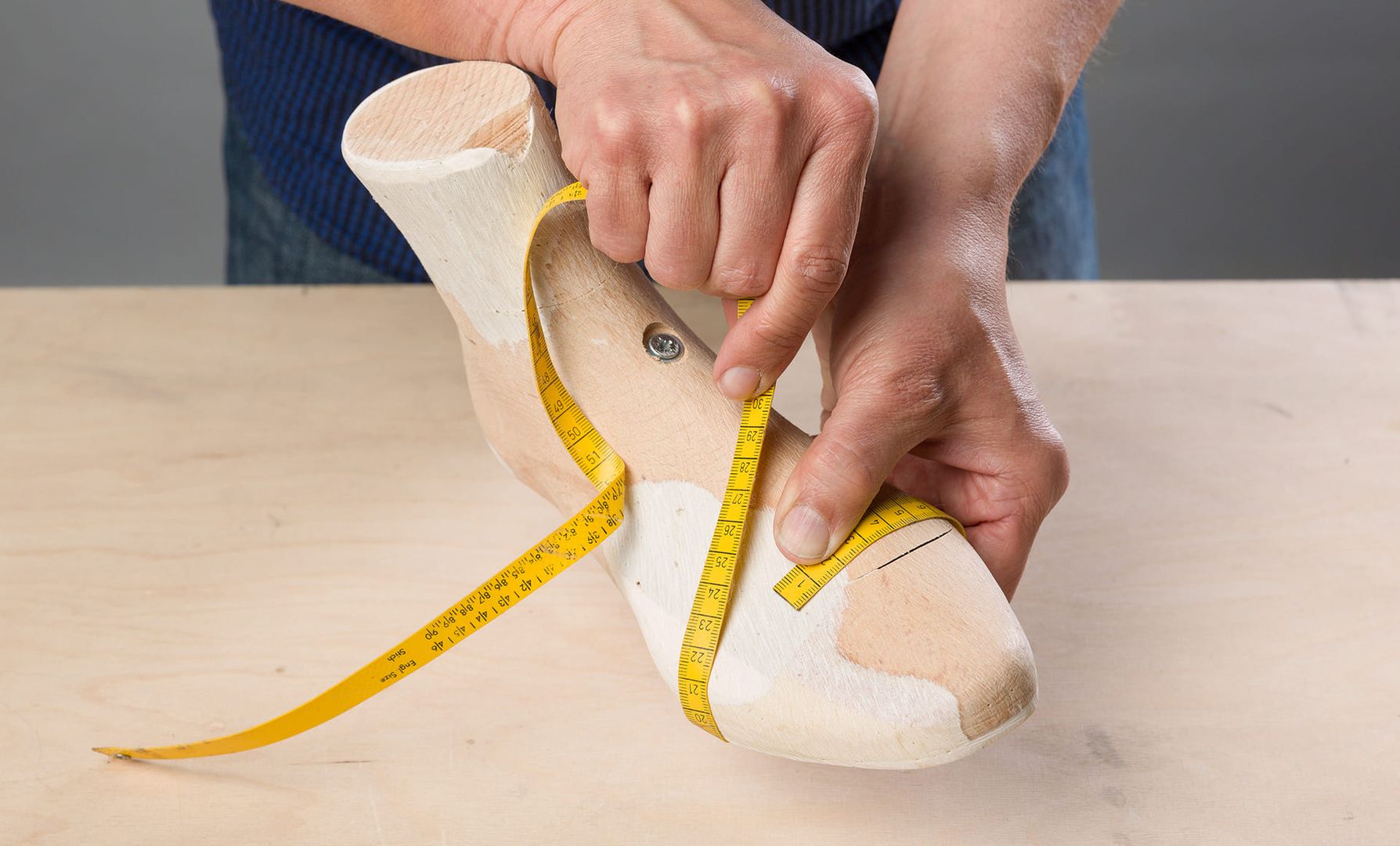 Vermessung eines Schuhleistens mit Maßband in der Orthopädie